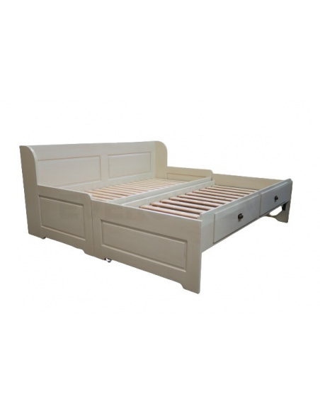 Rozkladacia posteľ z masívneho dreva s rozloženou prísteľkou a úložným priestorom v bielej farbe